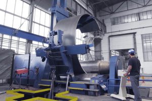 Faccin: blue plate bending machine with perfectly rolled can in a factory for wind tower production